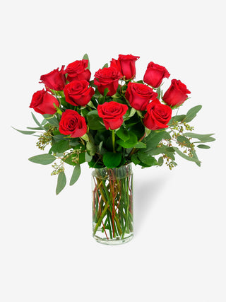 12 long-stem red roses arranged in a sleek vase, perfect for romantic occasions.