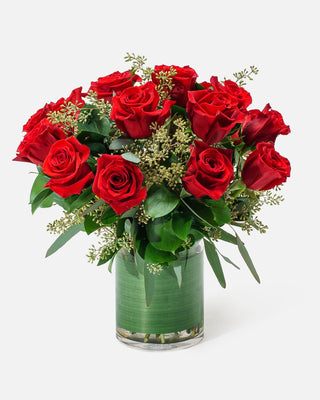 18 long-stem red roses arranged in a sleek vase, perfect for romantic occasions.