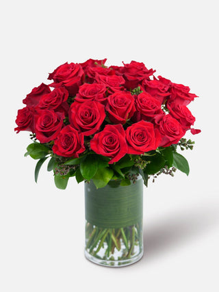 24 long-stem red roses arranged in a sleek vase, perfect for romantic occasions.