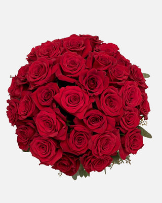 Three dozen premium red roses in a stylish vase, a timeless gift for anniversaries.